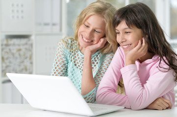 Two girls using laptop