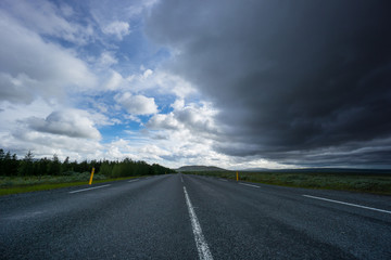 Iceland - Empty highway under dark thunderstorm clouds