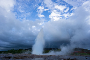 Fototapeta na wymiar Iceland - Turquoise hot boiling water, middle eruption of geyser strokkur