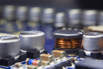 Close up macro of an Electromagnetic coil and electronic component mount in electronics motherboard...