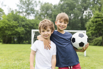 Two brothers having fun playing with ball