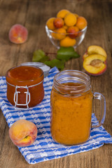 Healthy eating, food, dieting and vegetarian concept - smoothie from apricot and peach in mug, close up.