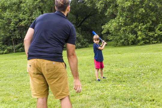 Happy Father And His Son Playing Baseball