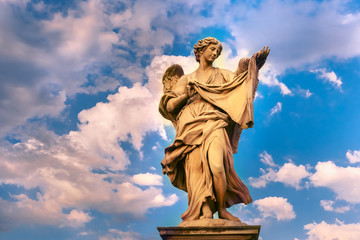 Marble statue of Angel with the Sudarium at sunset, one of the ten angels on Saint Angel Bridge, symbols of Christ's Passion, Rome, Italy