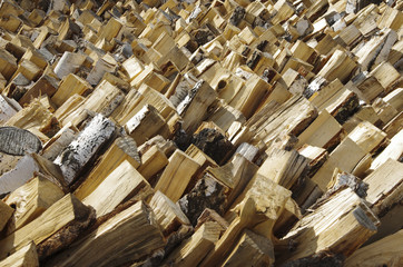 Pile of stacked firewood prepared for fireplace and boiler
