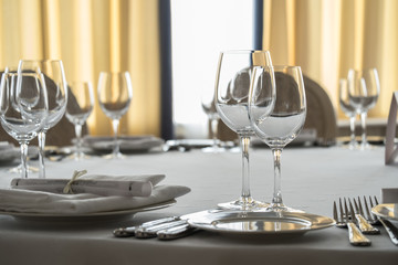 Empty glasses and plates set on the table in restaurant