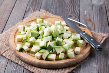 Chopped zucchini on wooden board