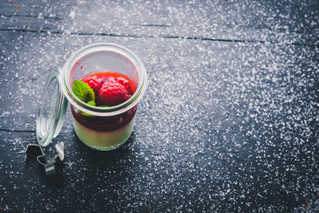 Creamy dessert with berries. On a wooden background. Top view. Free space for your text.