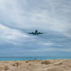 Fototapeta na wymiar Plane landing flying over famous Maho Beach