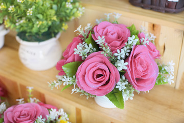 Pink roses gentle on wooden shelves. sweet color tone concept.