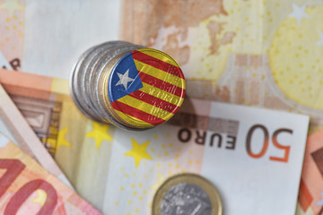 euro coin with national flag of catalonia on the euro money banknotes background