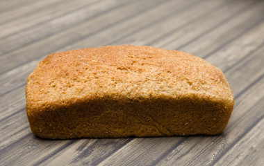 Whole Wheat Loaf of Bread on a Wooden Table
