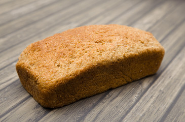 Whole Wheat Loaf of Bread on a Wooden Table