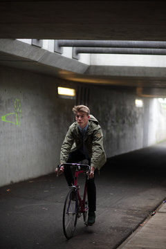 Young man with vintage bicycle in an urban bike  tunnel