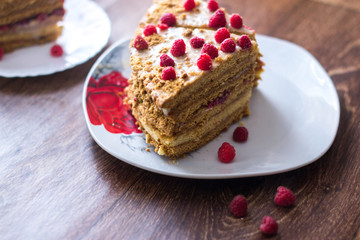 Homemade cake baking on a platter on a wooden background.