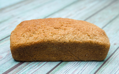 Loaf of Whole Wheat Bread on a Blue Wood Table
