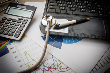 Medical stethoscope on the keyboard of computer