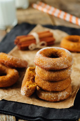 Baked pumpkin donuts with glasses of milk