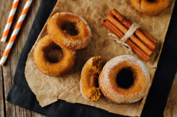 Baked pumpkin donuts with glasses of milk