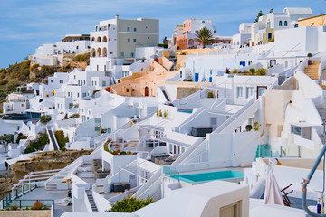 Oia town on Santorini island, Greece. Traditional and famous white and rose  houses at sunny day