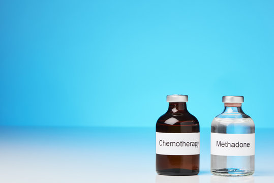 (English label in transverse format) An ampoule of methadone and a chemotherapy stand on white surface against a blue background at the right side of the image