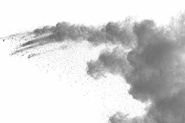 Abstract freeze motion of black dust explosion on white background. Stopping the movement of dark powder on white background. Explosive powder black on white background.