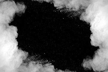 Freeze motion of white dust explosion on black background. Stopping the movement of white powder on dark background. Explosive powder white on black background. - 165841589