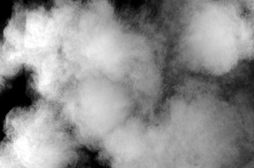 Freeze motion of white dust explosion on black background. Stopping the movement of white powder on dark background. Explosive powder white on black background.