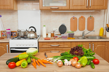 fresh fruits and vegetables on the table in kitchen interior, healthy food concept
