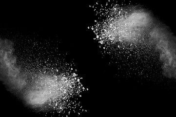 Freeze motion of white dust explosion on black background. Stopping the movement of white powder on dark background. Explosive powder white on black background. - 165842103