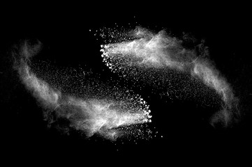Freeze motion of white dust explosion on black background. Stopping the movement of white powder on dark background. Explosive powder white on black background. - 165842117