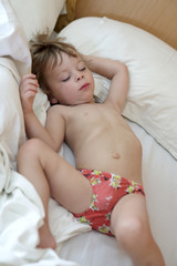 Obraz na płótnie Canvas Child sleeping on bed