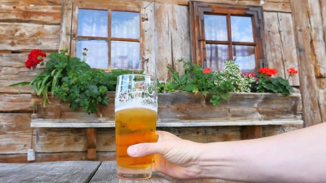 Beer drinking in front of mountain hut, Bavaria