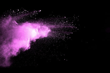 Abstract art colored powder on black background. Frozen abstract movement of dust explosion multiple colors on black background. Stop the movement of multicolored powder on dark background.