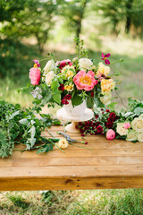 bouquet, holiday flower, gift and floral arrangement concept - wonderful bouquet in white vase on wooden table at green garden, white and yellow roses, pink peonies, red carnations, vertical