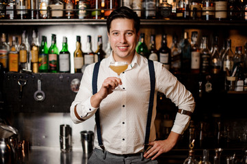 smiling bartender in white shirt with cocktail