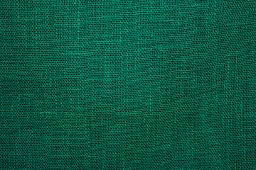 Green linen cloth close-up background. Fabric khaki teak canvas texture.