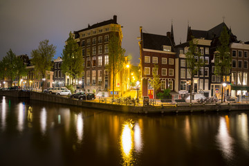 Fototapeta na wymiar Canals of Amsterdam at night. Amsterdam is the capital of the Netherlands