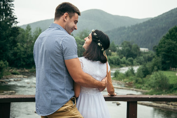 man with woman stands on the bridge across the river © phpetrunina14