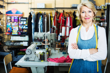 Tailor standing in sewing workshop