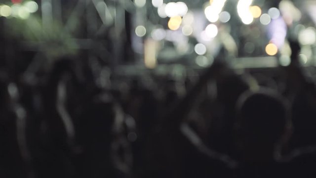 People crowd partying at a concert in slow motion