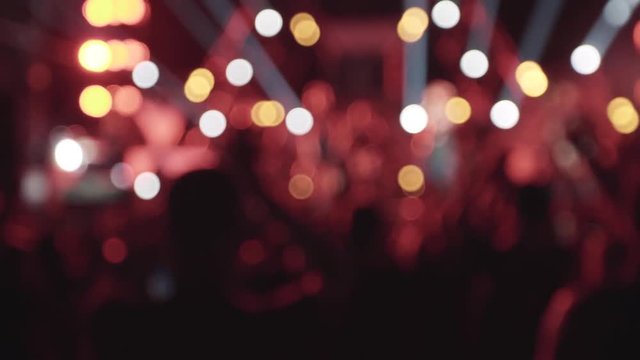 People crowd partying at a concert in slow motion