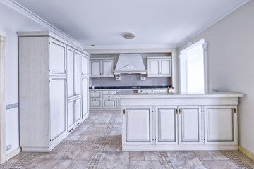 Modern design white kitchen in a spacious apartment.
