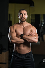 Fototapeta na wymiar Serious Bodybuilder Standing In The Gym