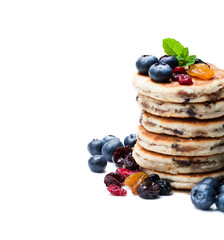 Stack  of welsh cakes with dry berries and fresh blueberries isolated on white