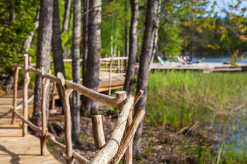 Wooden paths along the lake in the spring forest of Karelia 