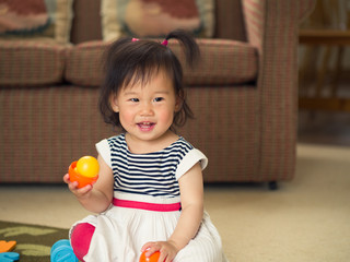 Fototapeta na wymiar baby girl playing toy at home