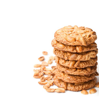 Stack  of sugar cookies with monkey nuts isolated on white