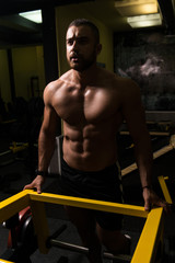 Muscular Man After Exercise Resting In Gym