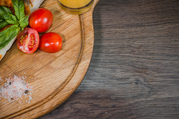 Hot piece of pizza with melted cheese on a rustic wooden table